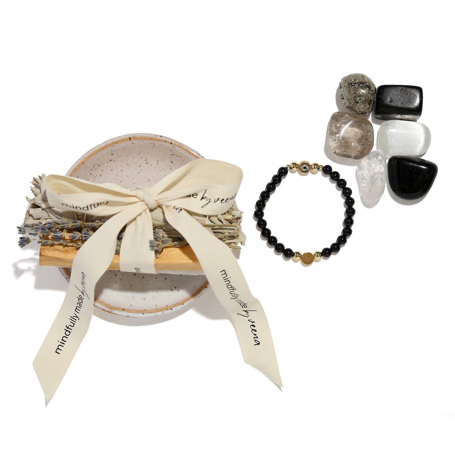 Bracelet and stones with a decorative box on a white background